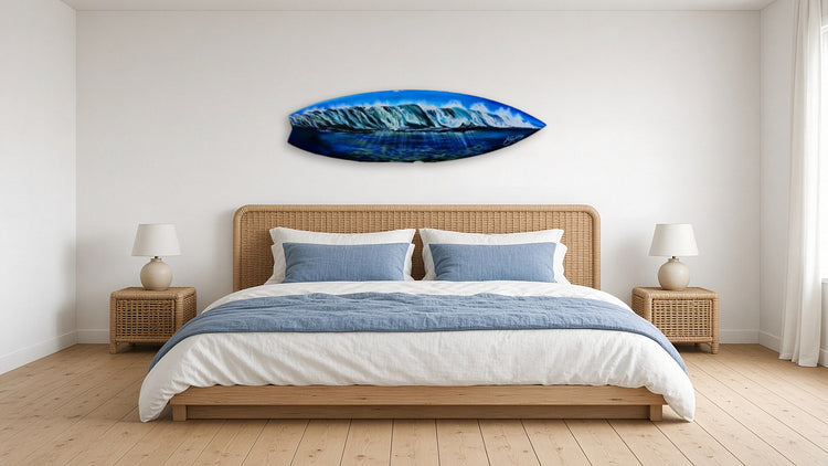 Waves Surfboard by Angie Hickson shown above a rattan headboard in a coastal bedroom