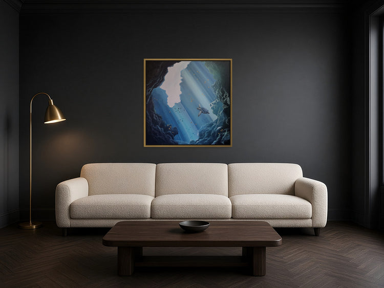 Below the Surface by Angie Hickson shown framed in brass above a sofa in a living room with a charcoal wall