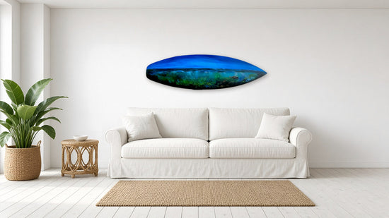 Deep Blue Drift by Angie Hickson shown above a sofa in a coastal living room