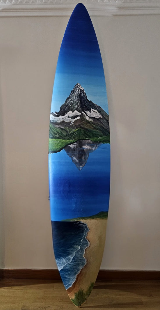 Serene Surfboard by Angie Hickson – hand-painted surfboard with a mountain reflected in a lake