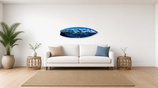 Waves Surfboard by Angie Hickson shown above a sofa in a coastal living room