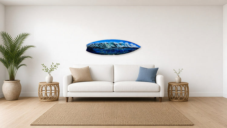 Waves Surfboard by Angie Hickson shown above a sofa in a coastal living room